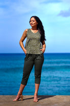 Woman wearing green pant and green print top.