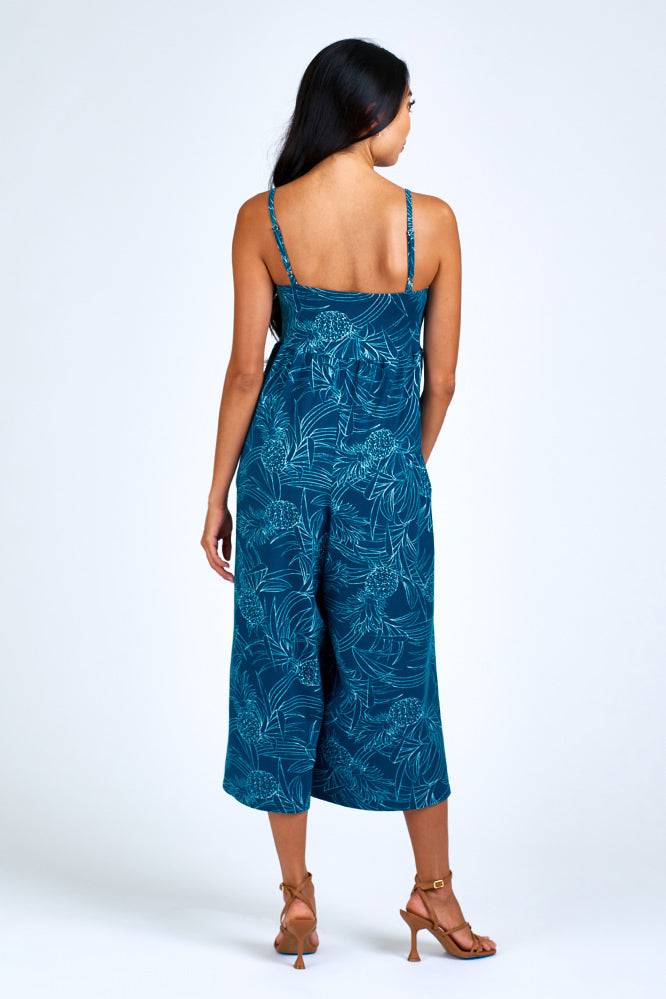 Woman wearing blue and cream jumpsuit.