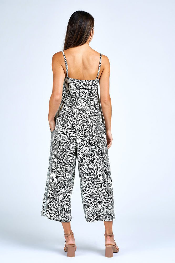 Woman wearing black and white jumpsuit.