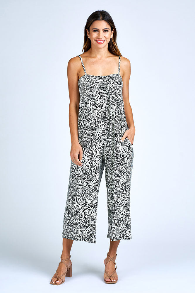 Woman wearing black and white jumpsuit.
