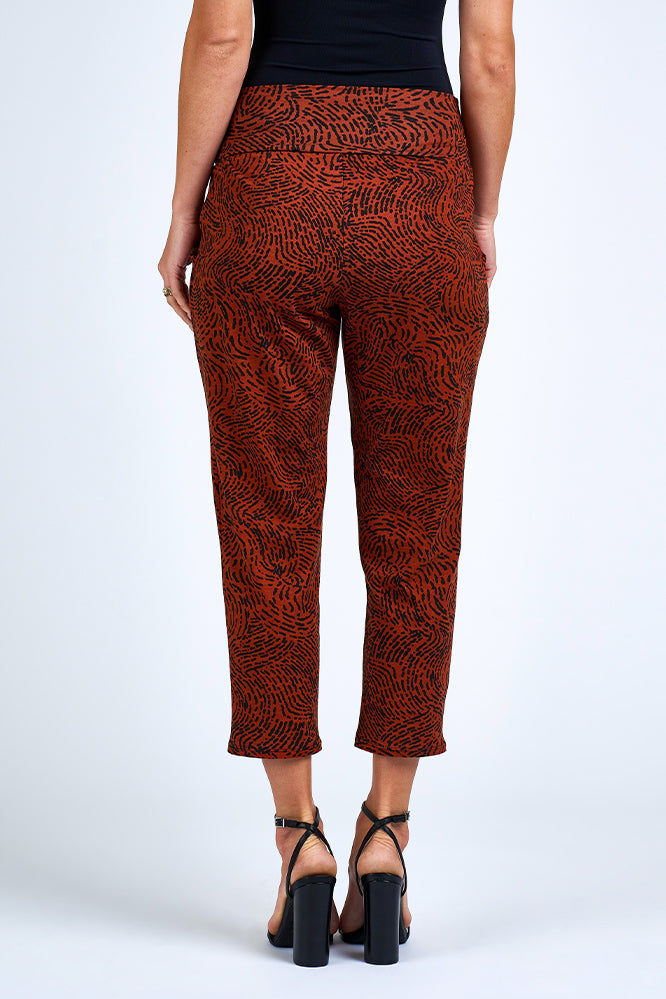 Woman wearing orange and black pants.