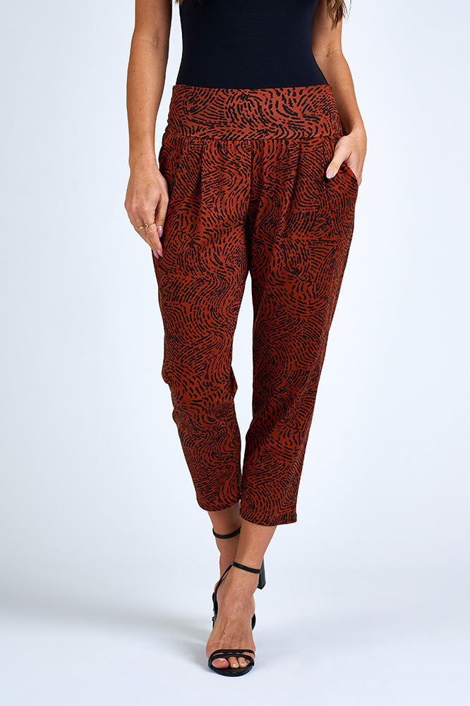 Woman wearing orange and black pants.