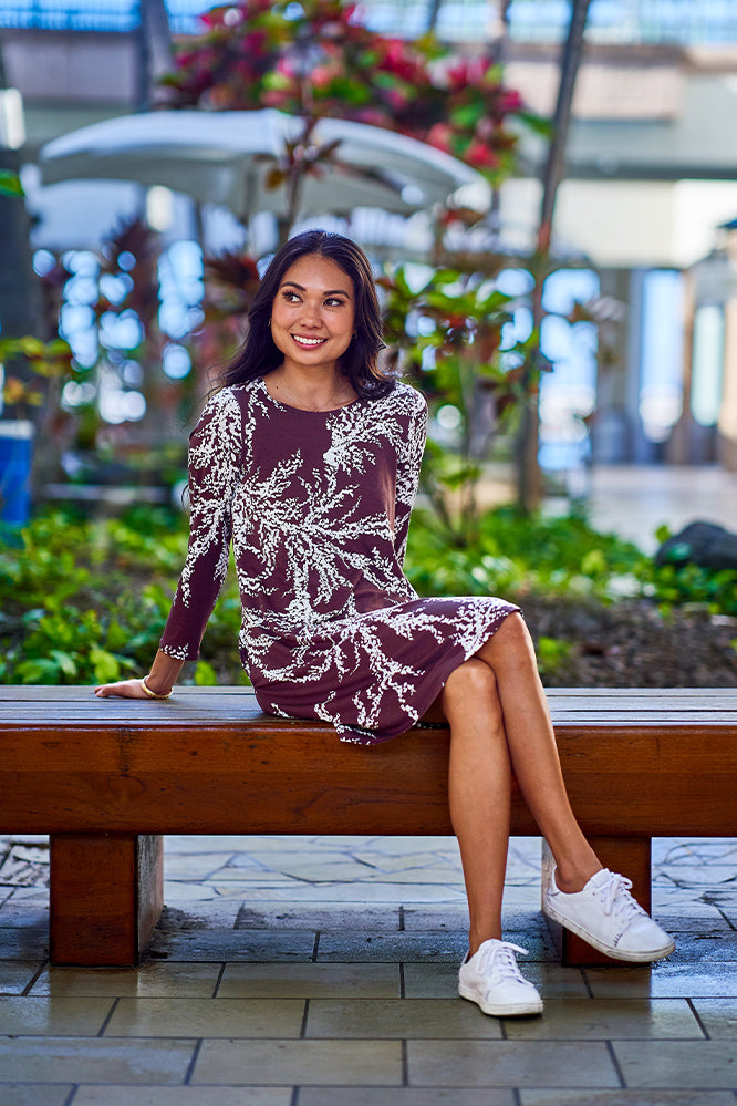 Woman wearing brown and white dress.