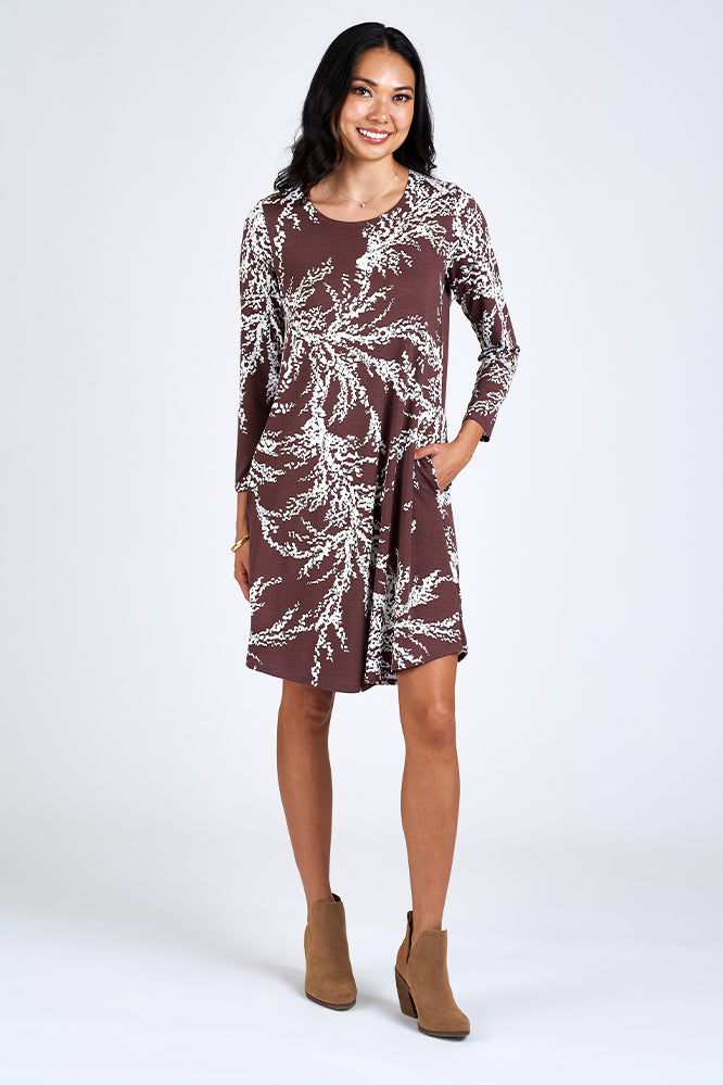 Woman wearing brown and white dress.