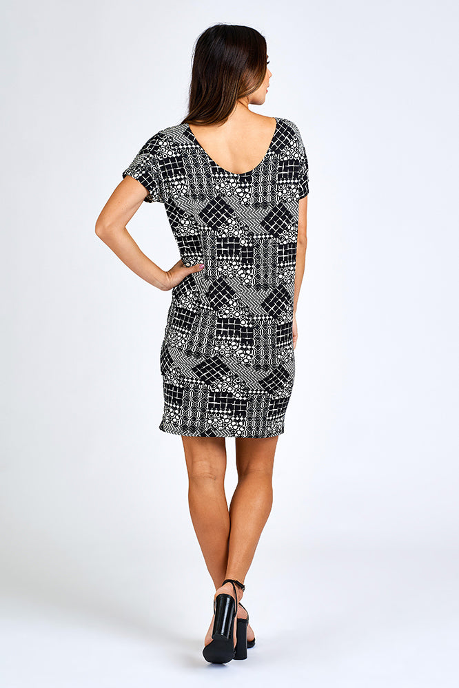 Woman wearing black and white print dress.