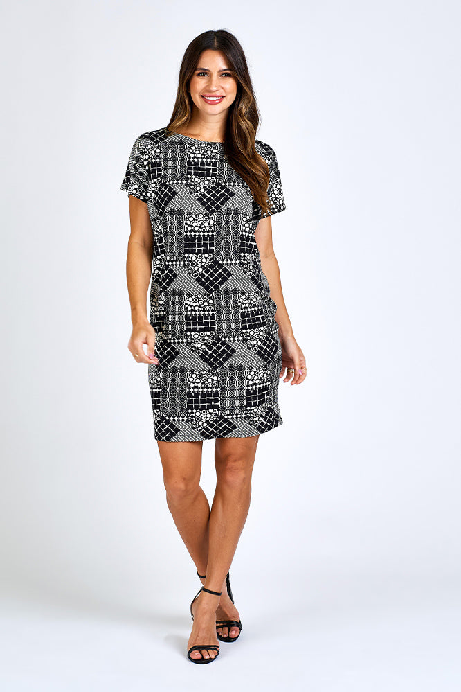 Woman wearing black and white print dress.