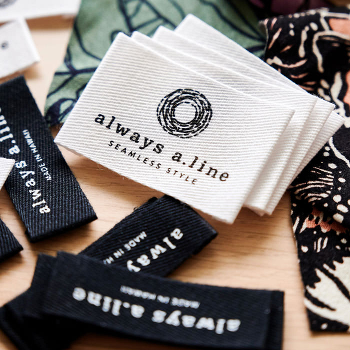 always a.line hangtags stacked on table.